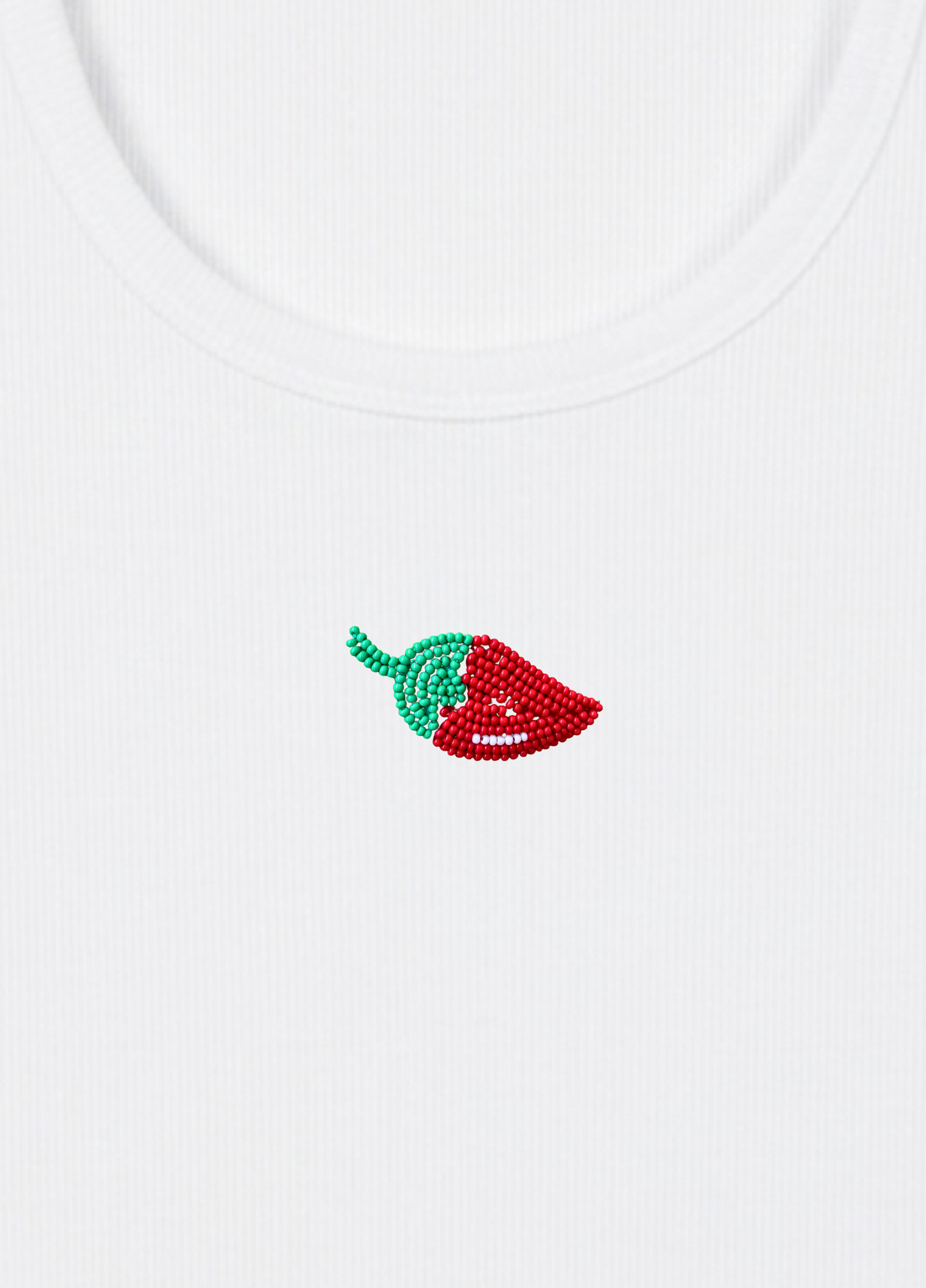 White tank top with a red and green chili pepper design on a light yellow background